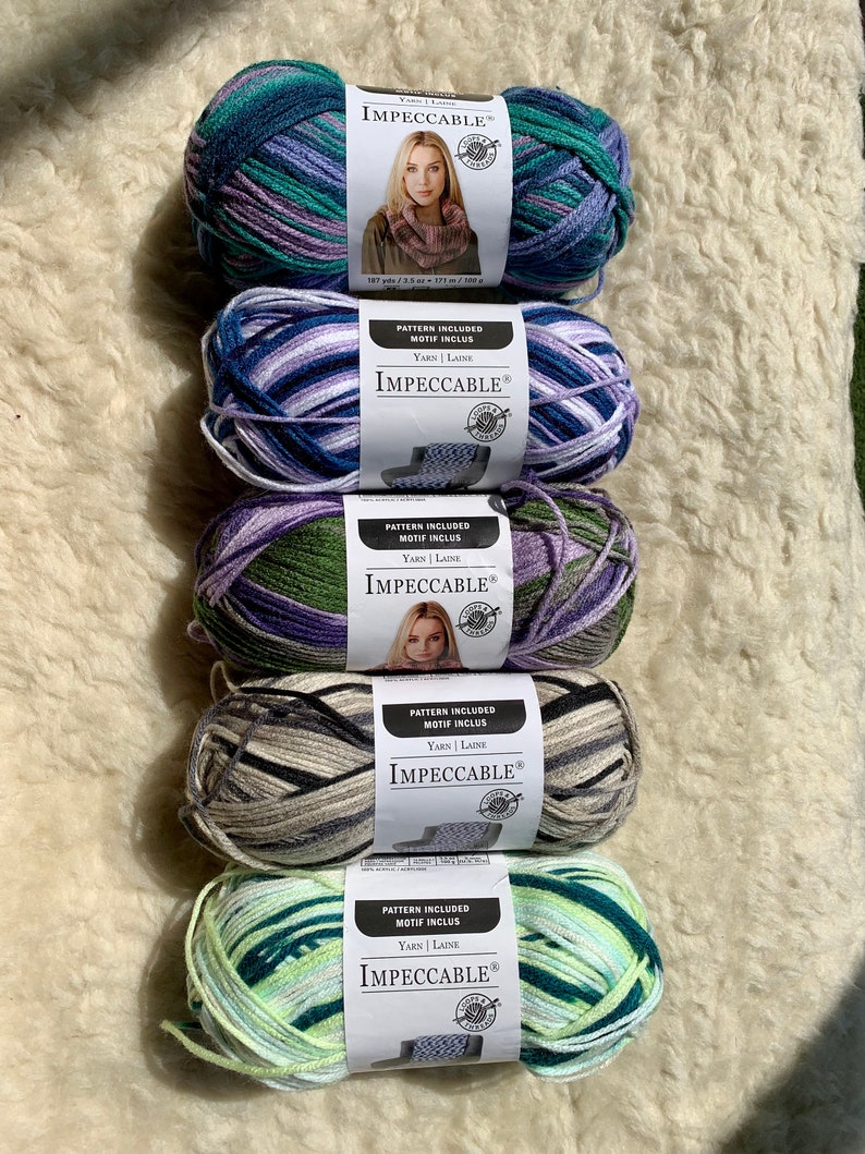 May include: Five skeins of yarn in different color combinations. Each skein has a label that reads "IMPECCABLE&reg;" and includes the text "PATTERN INCLUDED MOTIF INCLUS YARN | LAINE".