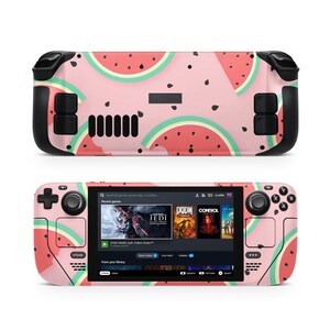 May include: A pink and black handheld gaming console with a watermelon pattern. The console has a screen displaying a game menu with titles like "Star Wars Jedi: Fallen Order" and "Doom Eternal".