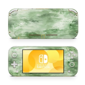 May include: A green and white Nintendo Switch Lite console with a watercolor design. The screen displays the Nintendo Switch logo against a yellow background. The console has a matte finish and a sleek design.