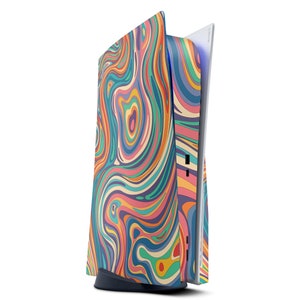 May include: A white gaming console with a colorful abstract swirl pattern skin. The console is standing upright with the disc drive open.