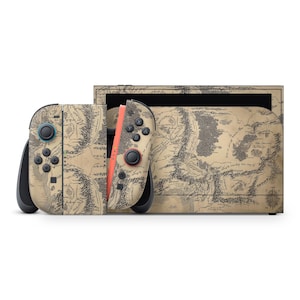 May include: A Nintendo Switch console and controllers featuring a map design in tan and black. The controllers have teal and coral accents. The console is set against a white backdrop.