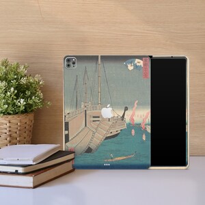 May include: A phone case with a Japanese woodblock print design featuring a ship with a blue and white sail and a red and white flag. The background is a blue sky with white stars and pink clouds.