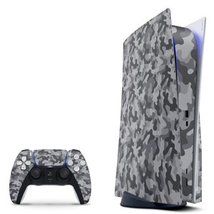 May include: A white and gray camouflage patterned PlayStation 5 console with a matching controller. The console is open and the disc drive is visible.