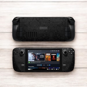 May include: A black handheld gaming device with a textured surface. The device has a screen displaying a Steam interface with game titles such as "Star Wars Jedi: Fallen Order" and "DOOM".
