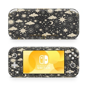 May include: A black Nintendo Switch Lite console with a custom skin featuring a celestial pattern of stars, moons, and clouds in gold and white on a black background. The console has a screen displaying the Nintendo Switch logo.