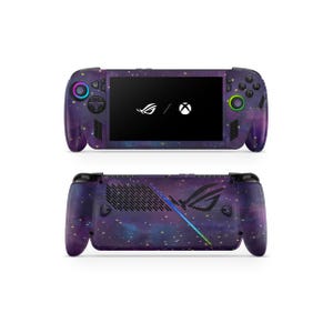 May include: A handheld gaming console with a galaxy-themed design. The device features a black screen with white logos and colorful buttons. The back of the console has a logo with a gradient light effect.