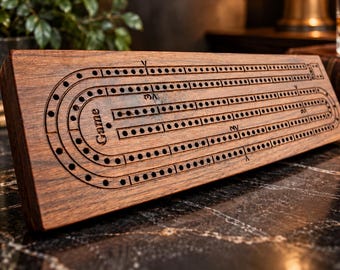 May include: A rectangular dark brown wooden cribbage board featuring three parallel tracks of drilled holes for scoring. The board includes engraved markings and the word Game printed on the left side, with a smooth finish and visible wood grain texture.