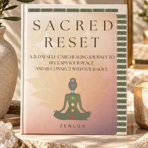 May include: A hardcover book titled Sacred Reset, a 21-day self-care healing journey to reclaim your peace and reconnect with your soul. The cover features a lotus flower graphic with seven colored chakra points and the brand name Zenlux.