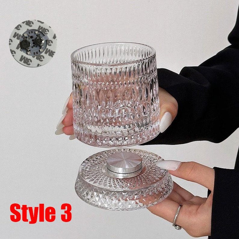 May include: A clear, textured glass tumbler and lid with a silver-colored center. The tumbler has a diamond pattern. The text "Style 3" is in red. A small, round adhesive pad is visible in the background.