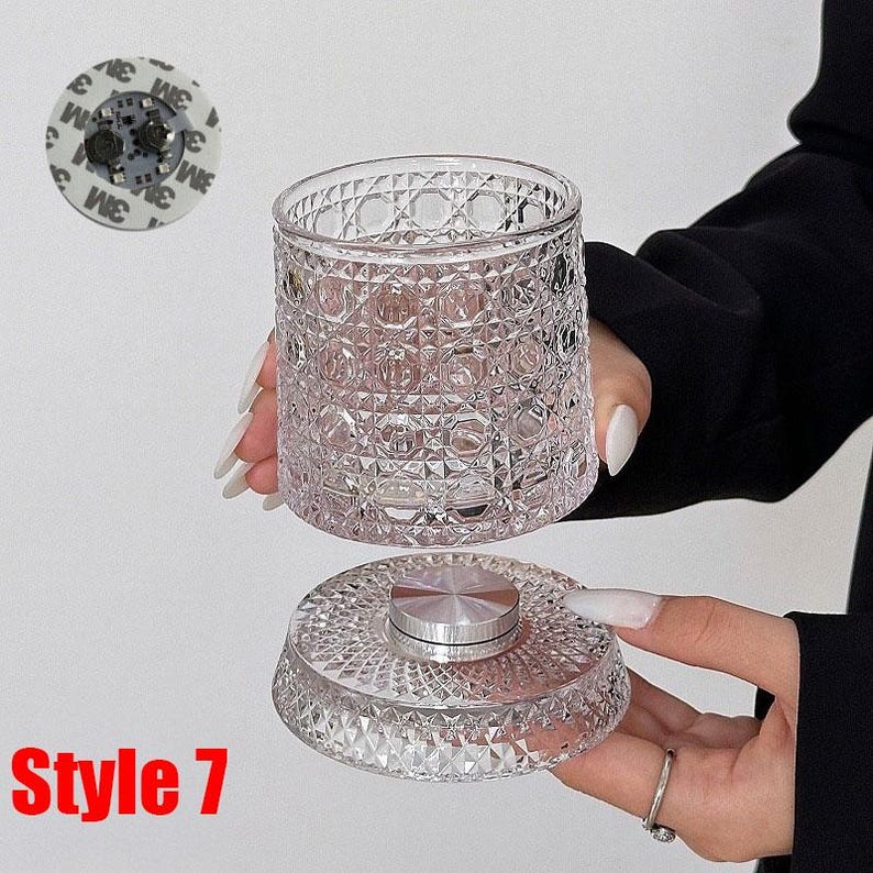 May include: A clear, diamond-patterned glass jar with a matching lid. The lid has a silver metal center. The jar is held in the air, with the lid below. The text "Style 7" is in the bottom left corner.