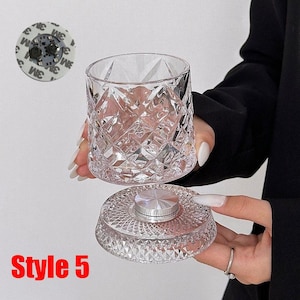 May include: A clear, diamond-cut glass tumbler and base. The base has a silver-colored, circular center. The tumbler is held above the base. The text "Style 5" is in red at the bottom.
