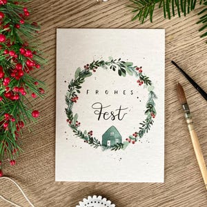 Weihnachtskarte „frohes Fest“ / Karte handmade Weihnachten / Winterlicher Watercolorkranz mit roten Beeren Eukalyptus und Häuschen auf A6