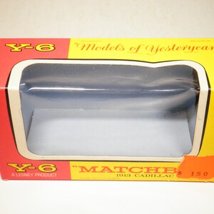 May include: A red and yellow box with a clear plastic window showing the inside. The box is labeled "Y-6" and "Models of Yesteryear" and features a Matchbox 1913 Cadillac toy car. The box also says "A Lesney Product" and "$1.50".