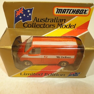 May include: A red Matchbox toy van with a white stripe and "We Deliver" printed on the side. The van is in a gold and red box with an Australian flag and "Australian Collectors Model" printed on the front. The box also says "Limited Edition".