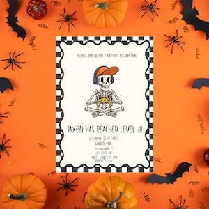 May include: Halloween-themed birthday invitation with a skeleton gamer illustration. The invitation features the text "Jaxon Has Reached Level 8!" and party details. The design includes pumpkins, bats, and spiders on an orange background.