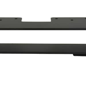 May include: A black metal shelf with a rectangular design. The shelf has a flat top with four holes and a lower shelf. The sides are solid, and the bottom has two small rectangular feet.