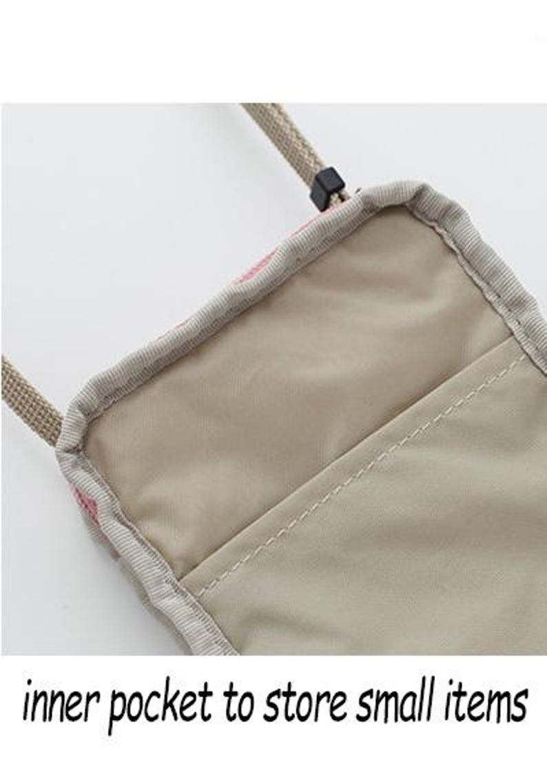 May include: A beige crossbody bag with a pink and white patterned design. The bag has a zipper closure and an inner pocket to store small items.