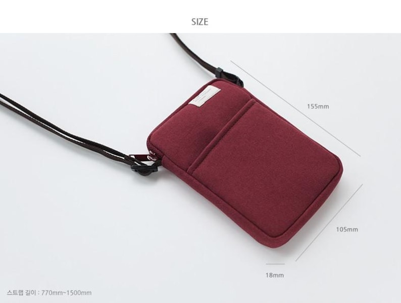 May include: A burgundy felt phone pouch with a zipper closure and a black adjustable strap. The pouch measures 5.7 inches wide, 4.1 inches tall, and 0.7 inches thick.