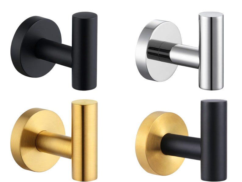 May include: Four different metal hooks in black, silver, gold, and black with a gold base. The hooks are all in the shape of a T and are designed to be mounted on a wall.