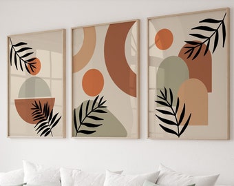 May include: Three abstract art prints with a neutral colour palette of beige, brown, and green. Each print features a different arrangement of geometric shapes and stylised leaves.