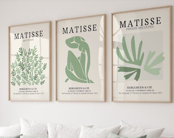 May include: Three framed art prints with a green and white color scheme. The prints feature the text "MATISSE" and "PAPIERS DECOUPES" along with abstract green shapes.