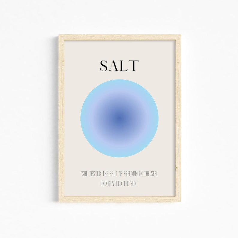May include: A framed print with a blue gradient circle and the word "SALT" in black text. The quote "SHE TASTED THE SALT OF FREEDOM IN THE SEA, AND REVELED THE SUN" is printed below the circle.