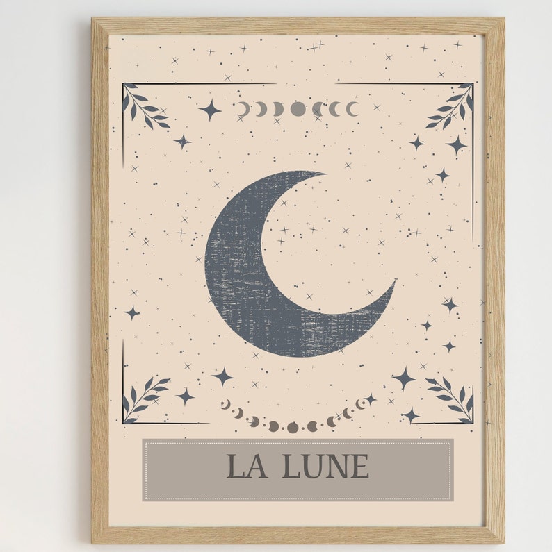 May include: A beige and blue illustrated print with a crescent moon, stars, and the text "LA LUNE" in a brown rectangle.