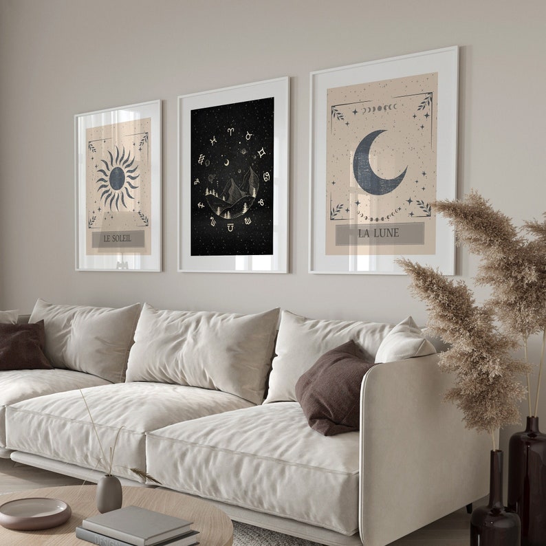May include: Three framed prints with celestial imagery. The prints are in black, white, and gold. The first print features a sun with the text "Le Soleil". The second print features a mountain range with stars and the text "La Lune". The third print features a crescent moon with stars and the text "La Lune".