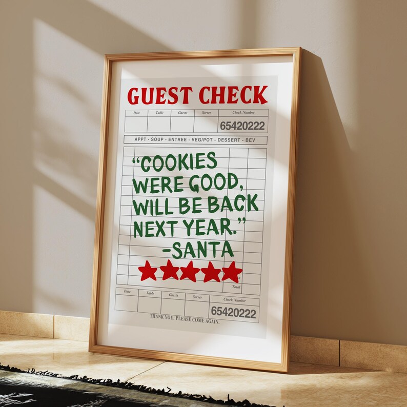 May include: A white framed print with a red and green guest check that reads "COOKIES WERE GOOD, WILL BE BACK NEXT YEAR." -SANTA with five red stars below the text. The check number is 65420222.