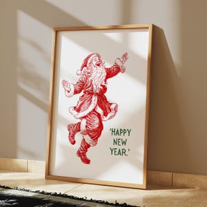 May include: A framed print of a red illustration of Santa Claus dancing with the text 'HAPPY NEW YEAR.'