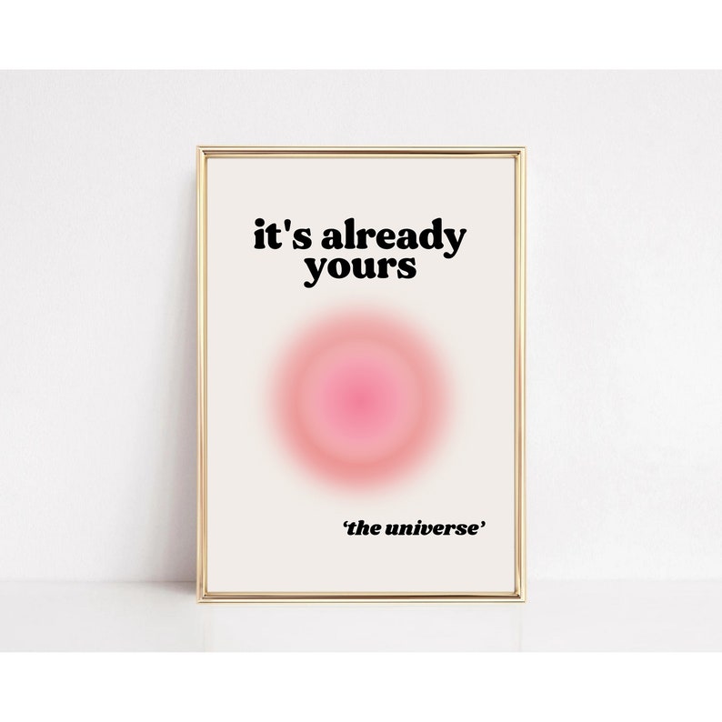 May include: A white framed print with a pink circle in the center and the text "it's already yours 'the universe'" in black.