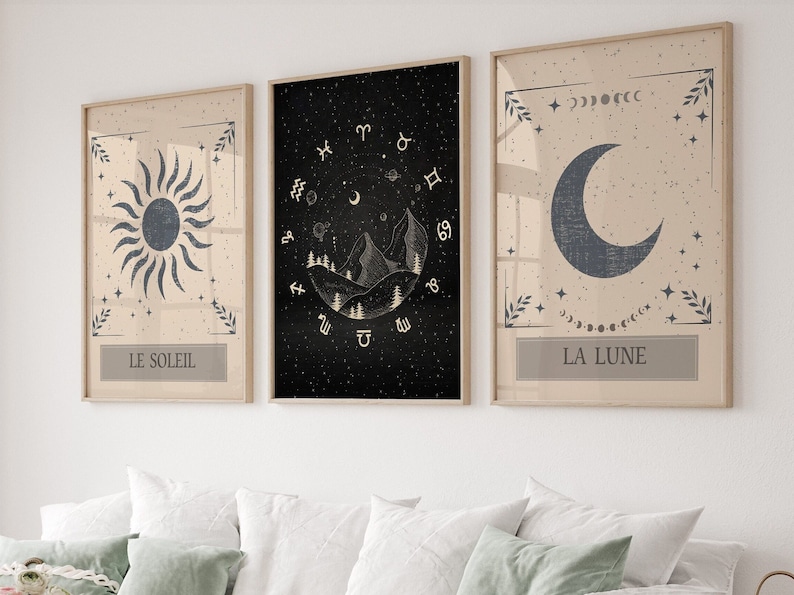 May include: Three framed prints with celestial themes. The left print features a sun with the text "LE SOLEIL". The middle print features a mountain range with zodiac symbols and the text "LE SOLEIL". The right print features a crescent moon with the text "LA LUNE".