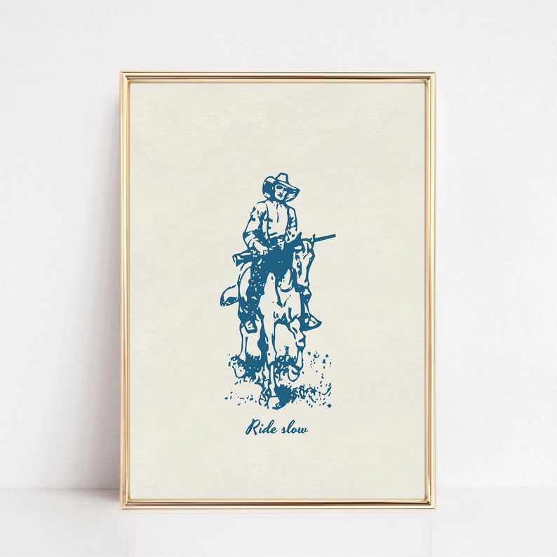 May include: A blue and white illustration of a cowboy riding a horse with a rifle. The text "Ride slow" is below the image.