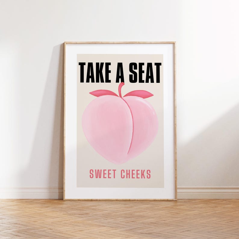 May include: A peach-shaped illustration with the text "TAKE A SEAT" above and "SWEET CHEEKS" below. The peach is pink and the text is black.