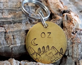 Dog ID tag engraved "OZ", round engraved brass tag