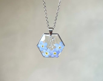 Resin necklace with forget-me-nots and gold or silver leaves. Hexagonal resin pendant with real forget-me-not flowers.