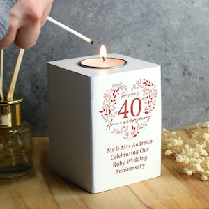 May include: White wooden candle holder with a red heart design that says "Happy 40th Anniversary". The text below the heart says "Mr & Mrs Andrews Celebrating Our Ruby Wedding Anniversary".