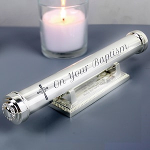 May include: Silver keepsake scroll with a cross engraved on the side. The scroll is engraved with the text "On Your Baptism" and a personalised message. The scroll is displayed on a silver stand.