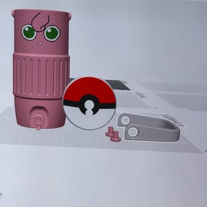 May include: A pink, cylindrical container with a cartoon face, a red and white circular design, and several grey components. The container has a spigot and a handle. The circular design resembles a Pokeball.