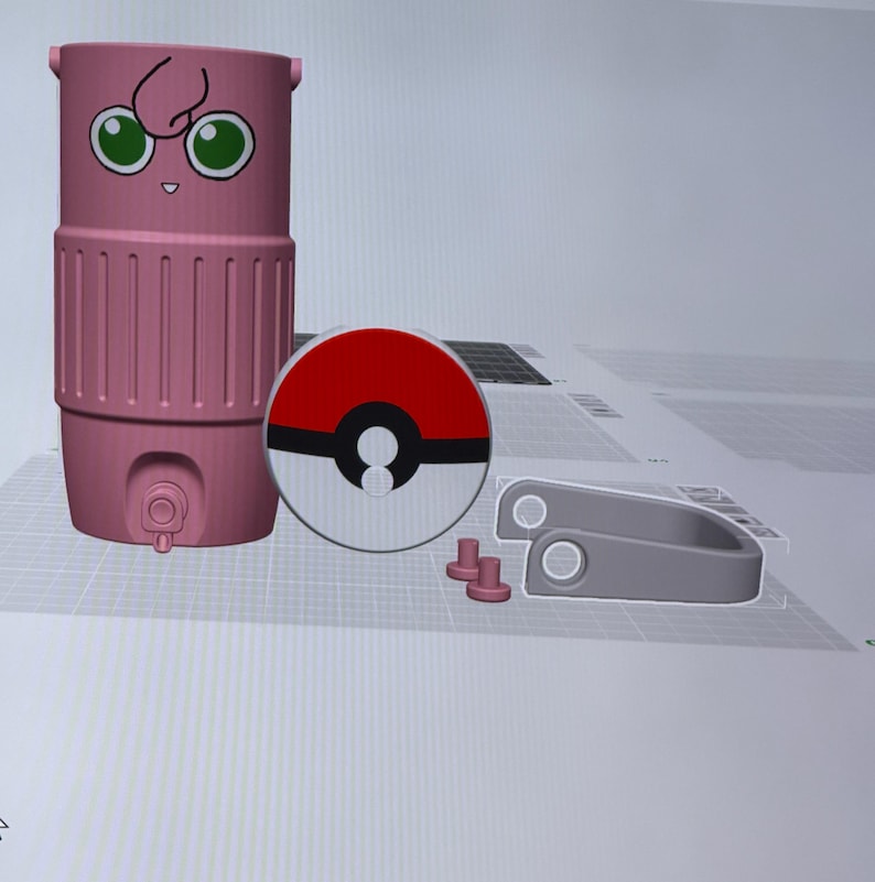 May include: A pink, cylindrical container with a cartoon face, a red and white circular design, and several grey components. The container has a spigot and a handle. The circular design resembles a Pokeball.