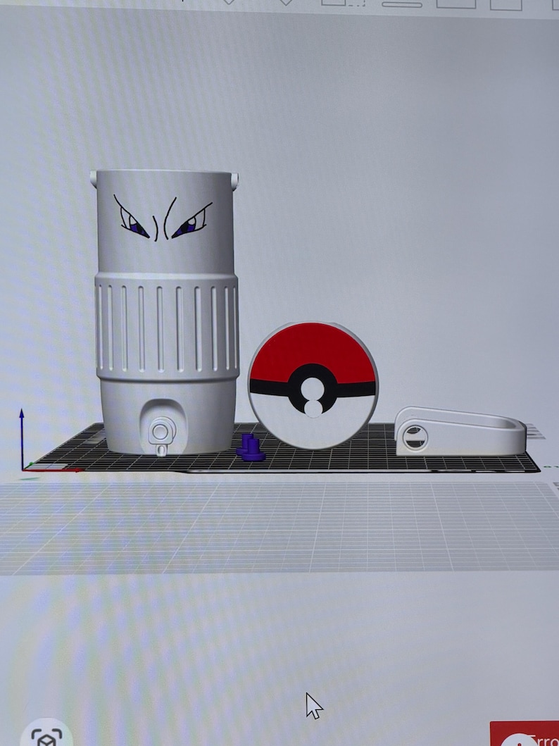 May include: A 3D-printed, light gray water bottle with a cartoon eye design, a red and white circular object, and a white handle. The water bottle has vertical ridges and a small spout. The circular object resembles a Pokeball.