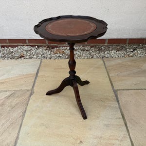 Mesa de vino de caoba estilo georgiano (reproducción) con tablero hexagonal de cuero verde y soportes estilo Reina Ana.