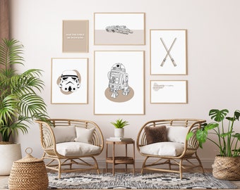May include: A living room interior with two wicker chairs, a side table, and a wall gallery of six framed prints featuring Star Wars characters and quotes. The prints include a quote from the movie, a drawing of a lightsaber, a drawing of R2-D2, a drawing of a Stormtrooper, a drawing of the Millennium Falcon, and a quote about the Force.