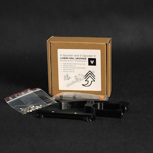May include: A hardware kit for a V-Spooler and V-Spooler X linear rail upgrade. The kit includes printed parts, screws, and nuts. The box has the product name and a list of included components.