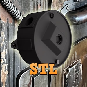 Puede incluir: Un objeto cilíndrico negro con un diseño geométrico y las letras "STL" en naranja. El objeto tiene una parte superior circular con un agujero central y está montado sobre una superficie metálica texturizada.