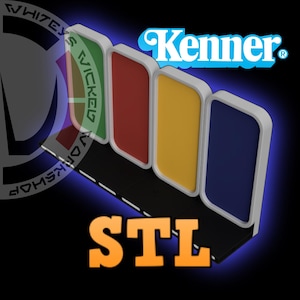 May include: A 3D-rendered design featuring four rectangular panels in green, red, yellow, and blue, with white borders. The Kenner logo is visible, along with the text "STL" in orange. The design is set against a dark blue background.