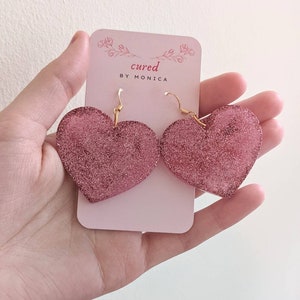 Big shimmery pink heart earrings, glittery, sparkly, wide, resin, cute, feminine, love themed earrings