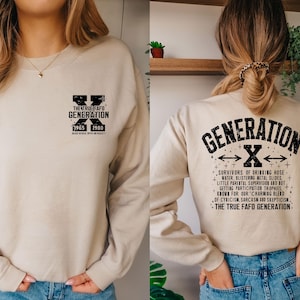 May include: A beige sweatshirt with black text that reads "The True Fafo Generation" and "Generation X" with the years 1965 and 1980. The back of the sweatshirt has a black graphic of a large "X" with arrows pointing to the left and right. The text below the "X" reads "Survivors of drinking hose water, blistering metal slides, little parental supervision and not getting participation trophies. Know for our charming blend of cynicism, sarcasm and scepticism. The True Fafo Generation."