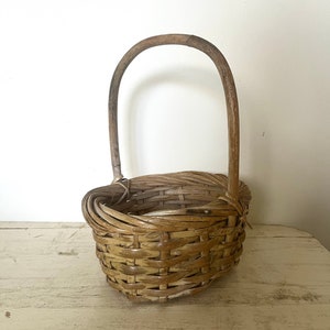 Vintage handmade oval wicker gathering basket with a bentwood handle