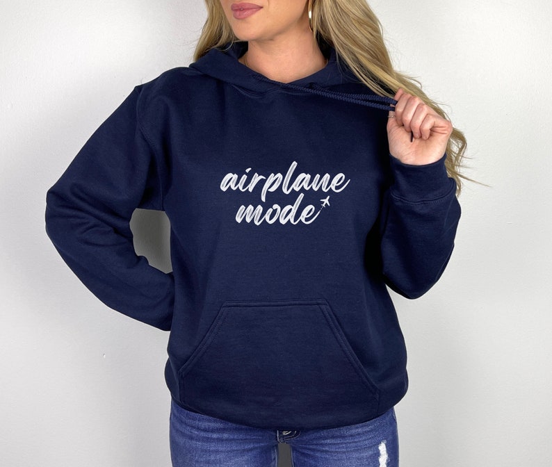 May include: Navy blue hoodie with a front pocket and drawstring. The white text "airplane mode" is printed on the front, with a small airplane graphic. A casual, comfortable sweatshirt for everyday wear.